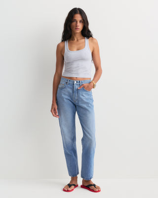 The Straight Jean - Light Wash is a pair of light blue, high-rise denim jeans featuring five pockets and a slightly faded finish. Expertly crafted in Italy, these jeans are laid flat to showcase their classic straight-leg silhouette.