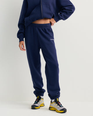 Brianno Serif Logo Embroidered Jogger in Dark Navy, featuring an elastic waistband and cuffs with a small white embroidered logo on the left thigh—a classic jogger inspired by the iconic Sporty & Rich sweatpant.