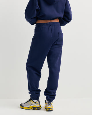 Brianno Serif Logo Embroidered Jogger in Dark Navy, featuring an elastic waistband and cuffs with a small white embroidered logo on the left thigh—a classic jogger inspired by the iconic Sporty & Rich sweatpant.