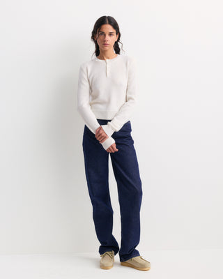 The Iba S Logo Cashmere Henley in Off White features long sleeves, ribbed cuffs and hem, and a three-button placket at the collar. Crafted from a luxurious cashmere-wool blend, this sweater offers both warmth and timeless style.