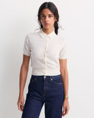 Jannie Signature Logo Cashmere SS Cardigan in Off White, featuring a short-sleeve cropped design with front buttons, displayed on a plain background.