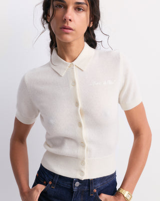 Jannie Signature Logo Cashmere SS Cardigan in Off White, featuring a short-sleeve cropped design with front buttons, displayed on a plain background.