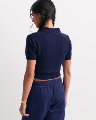 Jannie Signature Logo Cashmere SS Cardigan in Dark Navy—this cropped, short-sleeve knit features a button front, classic collar, and subtle signature embroidery on the left chest for a modern touch.