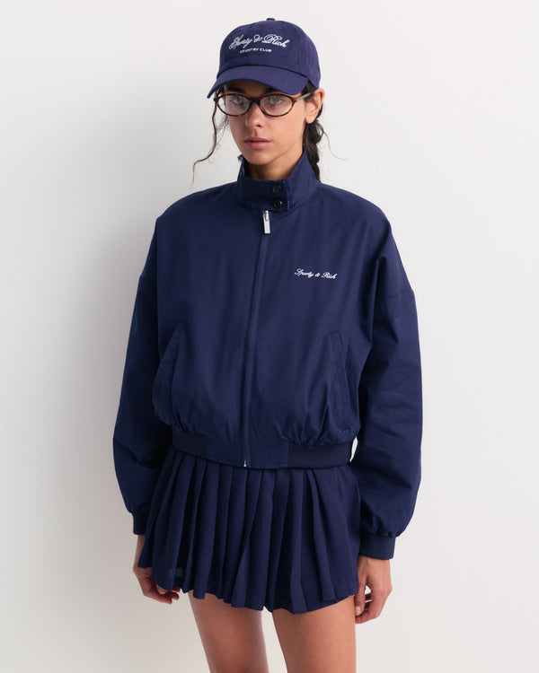 Gora Signature Logo Brighton Jacket in Dark Navy, featuring a collar and Sporty & Rich text on the left chest, laid flat on a white background.