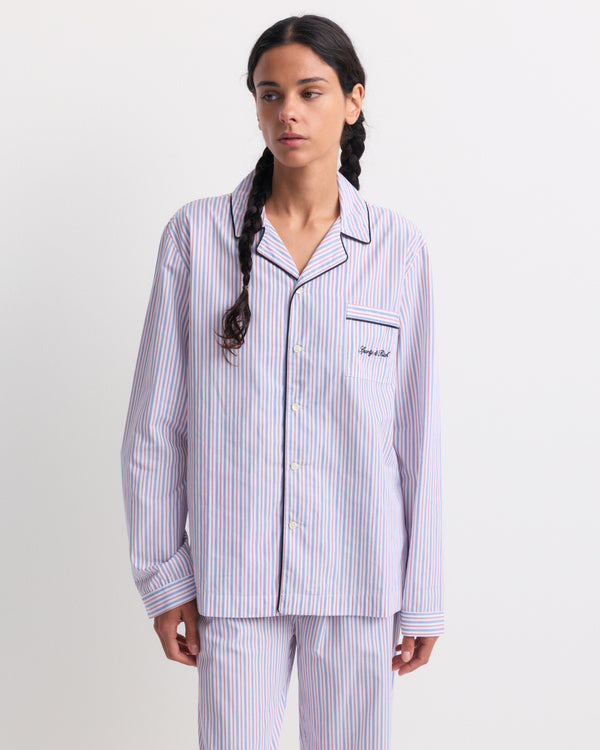 Cardona Signature Logo Pyjama Shirt – Blue White Red Striped. This long-sleeve, button-up pyjama shirt features blue, red, and white stripes and a chest pocket. Designed with an oversized unisex fit and made from breathable cotton for all-night comfort.