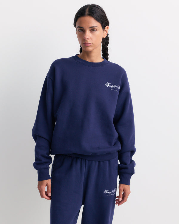 Emmett Club Script Crewneck in Dark Navy features a small white script on the left chest, inspired by vintage sweatshirts for a timeless, sporty & rich style.
