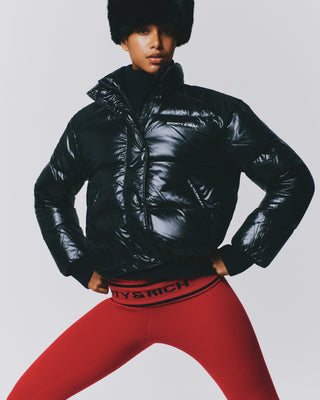 Black Devan Bold Logo Mountain Puffer with a boxy fit, mock neck, front zip, and white chest logo.