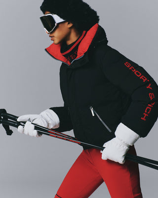 Drea Bold Logo Ski Jacket in black with an oversized fit, red interior collar, and red sleeve text.