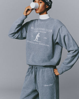 Medium Heather Gray Emmett St Moritz Crewneck sweatshirt featuring a Ski & Country Club St. Moritz graphic.