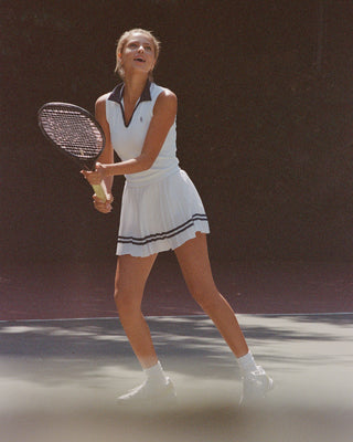 Woman playing tennis on a court with a racket