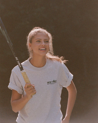 Woman holding a tennis racket with a blurred background