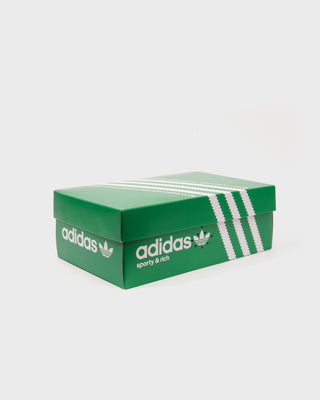 Green Adidas shoe box with white logo on a white background