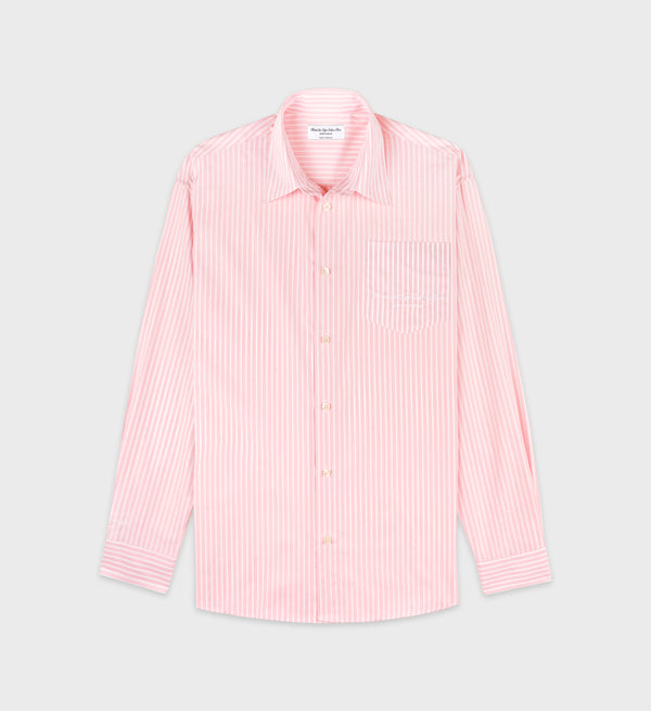 The Eden Script Oversized Shirt in pink/white thin stripe features a cotton poplin build, long sleeves, vertical stripes, front pocket, and an oversized fit, shown laid flat on a gray background.