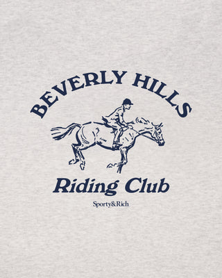 Logo of Beverly Hills Riding Club with a horse and rider illustration on a light gray background.