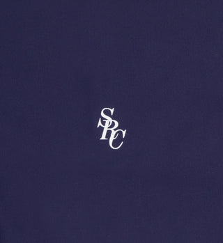 Centered on a plain dark blue background, a white SRC monogram in serif font captures the timeless elegance of the Brigitte Bikini Top - Navy by Sporty & Rich Swimwear, crafted with ECONYL® regenerated Nylon.