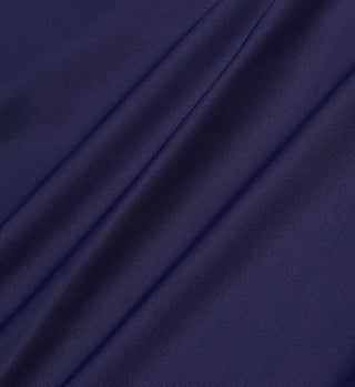 Smooth navy blue ECONYL® regenerated Nylon with soft folds and subtle sheen creates a gentle, flowing texture—perfect for the Brigitte Bikini Top - Navy.