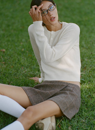 The Iba S Logo Cashmere Henley in Off White features long sleeves, ribbed cuffs and hem, and a three-button placket at the collar. Crafted from a luxurious cashmere-wool blend, this sweater offers both warmth and timeless style.