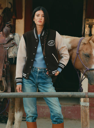Diana Riding Club Wool Varsity Jacket in chocolate and oatmeal with a circular horse-and-rider logo on the chest.