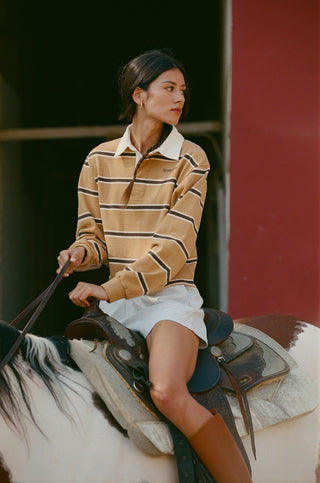 Blondie Serif Logo Rugby Polo in camel, chocolate, and cream horizontal stripes with a white collar.
