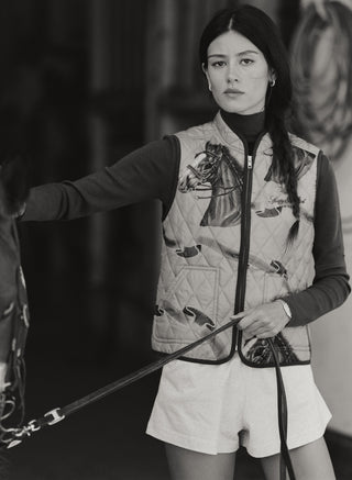 Gemma Vendome Quilted Riding Vest - Camel/Chocolate, a tan quilted equestrian vest with a horse and ribbon print.