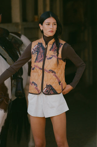 Gemma Vendome Quilted Riding Vest - Camel/Chocolate, a tan quilted equestrian vest with a horse and ribbon print.