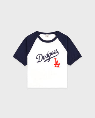 Dodgers Serif Baby Baseball Tee in White, Dark Navy, and Fire Red—crafted from 100% cotton, this stylish cropped raglan shirt features bold Dodgers text and a red LA logo on the front.