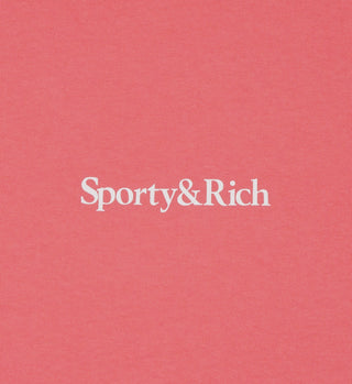 The Drink More Water Cropped T-Shirt in Strawberry/White features Sporty & Rich printed in white on pink fabric. Made in the USA from 100% USA cotton.