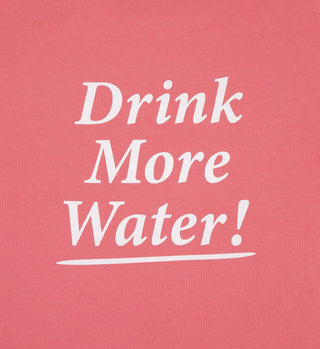 White text on a pink background reads Drink More Water! with an underline—perfect for the Drink More Water Cropped T-Shirt - Strawberry/White, made in the USA from 100% US cotton.