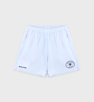 The Eden Crest Gym Short in ciel/navy features light blue cotton jersey fabric, an elastic waistband, side pockets, and two small embroidered logos on the front. Made in Portugal.