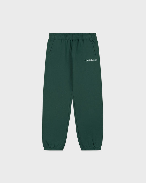 The Serif Logo Kids Sweatpant in Forest/White features an elastic waistband and cuffs, along with the signature Sporty & Rich text on the left thigh. Designed with an oversized fit, these dark green sweatpants are a stylish addition to any child’s wardrobe.