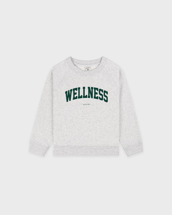 Wellness Ivy Kids Crewneck in Heather Gray/Forest, featuring "WELLNESS" in green block letters on the front, with an oversized fit and classic raglan sleeves, laid flat on a white background.