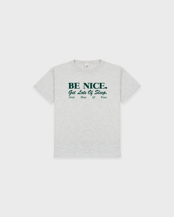 The Be Nice Kids T-Shirt - Heather Gray/Forest is crafted from recycled cotton and features the text: BE NICE. Get Lots Of Sleep. Drink Plenty Of Water. With its oversized fit, this essential piece is ideal for kids' clothing collections that prioritize comfort and style.