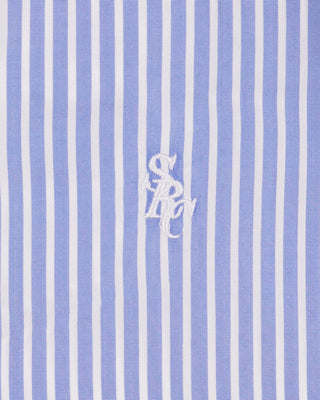 Blue and white striped fabric with a logo in the center