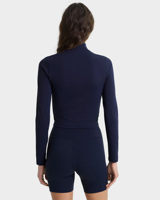 Navy blue athletic outfit worn by a person on a white background