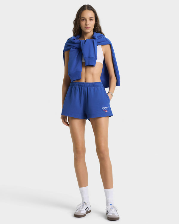 Person wearing a blue outfit with a matching jacket on a white background