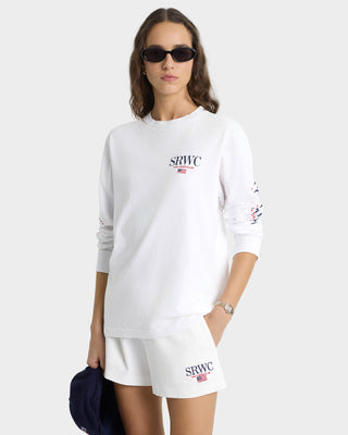 Woman wearing a white sweatshirt and shorts with 'SRWC' branding on a white background