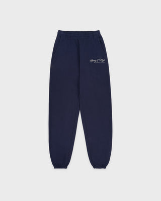 Navy blue sweatpants with a logo on the left leg against a white background