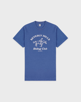 Blue t-shirt with 'Beverly Hills Riding Club' text and graphic on a light gray background