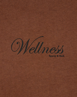 Brown fabric with 'Wellness' and 'Sporty & Rich' text in black.