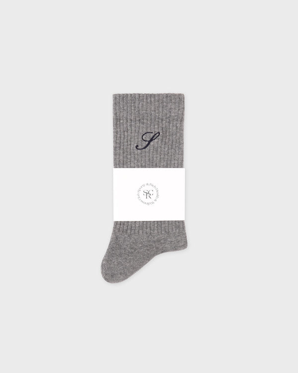 Gray sock with a monogram on a white background