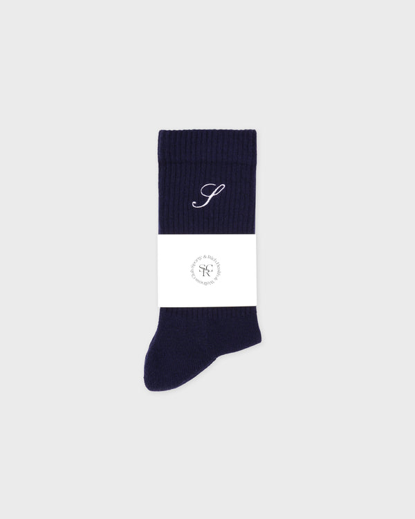 Navy blue sock with a white label on a light gray background