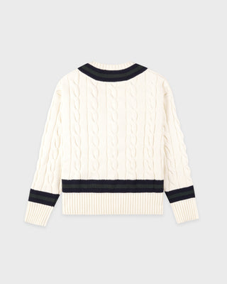 White sweater with black ribbed details on a light gray background