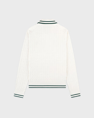 White ribbed sweater with green trim on a light gray background