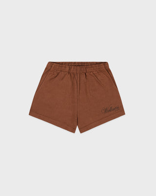 Brown shorts with a brand logo on a light gray background