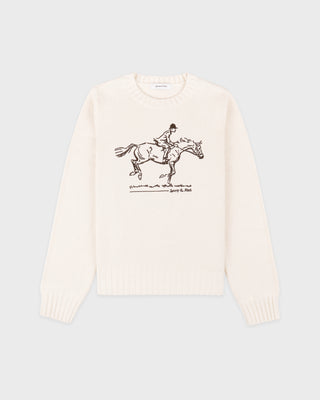 White sweater with horse and rider graphic on a light gray background