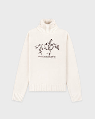 White turtleneck sweater with horse and rider graphic on a light gray background
