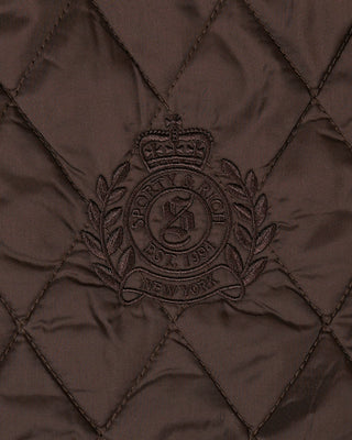 Quilted brown fabric with a embroidered logo and text