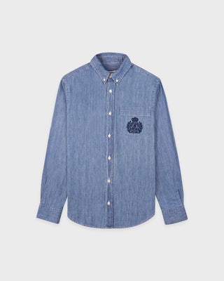 Blue denim shirt with a logo on a light gray background