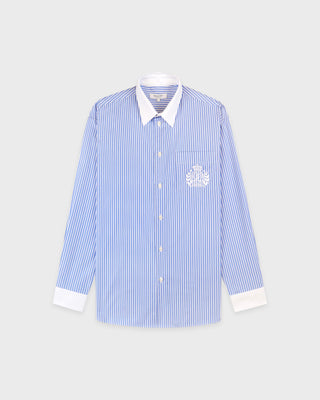 Blue and white striped shirt with a logo on a light gray background