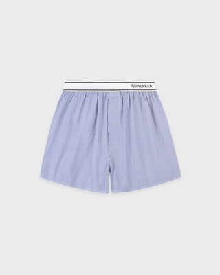 Blue and white striped boxer shorts with a brand label on a light gray background